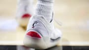 Jan 11, 2025; Cincinnati, Ohio, USA;  The Cincinnati logo is seen on a pair of Air Jordan shoes worn by a member of the Cincinnati Bearcats before the game against the Kansas Jayhawks at Fifth Third Arena. Mandatory Credit: Aaron Doster-Imagn Images
