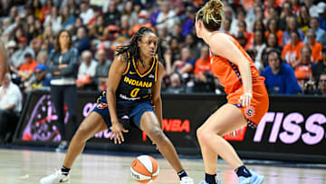 Sep 22, 2024; Uncasville, Connecticut, USA; Indiana Fever guard Kelsey Mitchell (0) dribbles the ball defended by Connecticut Sun guard Marina Mabrey (4) during game one of the first round of the 2024 WNBA Playoffs at Mohegan Sun Arena. Mandatory Credit: Mark Smith-Imagn Images