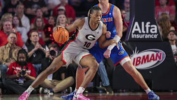 Feb 25, 2025; Athens, Georgia, USA; Georgia Bulldogs forward RJ Godfrey (10) dribbles against Florida Gators center Micah Handlogten (3) during the second half at Stegeman Coliseum. Mandatory Credit: Dale Zanine-Imagn Images