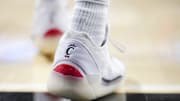 Jan 11, 2025; Cincinnati, Ohio, USA;  The Cincinnati logo is seen on a pair of Air Jordan shoes worn by a member of the Cincinnati Bearcats before the game against the Kansas Jayhawks at Fifth Third Arena. Mandatory Credit: Aaron Doster-Imagn Images
