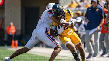 WVU wide receiver Cam Vaughn is tackled by a Robert Morris defender during a game at Milan Puskar Stadium in Morgantown, W.Va on August 30, 2025.