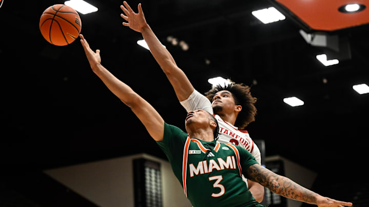 Jan 22, 2025; Stanford, California, USA; Miami (FL) Hurricanes guard Jalil Bethea (3) attempts a layup against Stanford Cardinal forward Donavin Young (2) in the first half at Maples Pavilion. Mandatory Credit: Eakin Howard-Imagn Images