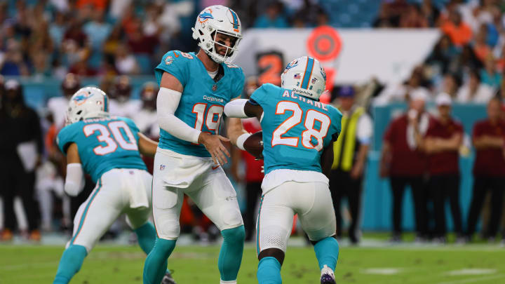 Miami Dolphins running back De'Von Achane (28) takes a handoff from quarterback Skylar Thompson (19) during the second quarter of a preseason game at Hard Rock Stadium.