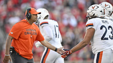 Oct 4, 2025; Louisville, Kentucky, USA; Virginia Cavaliers head coach Tony Elliott celebrates with defensive lineman Jacob Holmes (23) during the second half against the Louisville Cardinals at L&N Federal Credit Union Stadium. Virginia defeated Louisville 30-27. Mandatory Credit: Jamie Rhodes-Imagn Images