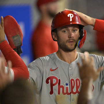 Apr 29, 2024; Anaheim, California, USA; Philadelphia Phillies shortstop Trea Turner (7) is greeted in the dugout after he scored on a sacrifice fly by third baseman Alec Bohm (not pictured) in the ninth inning against the Los Angeles Angels at Angel Stadium