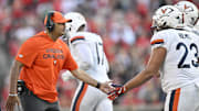 Oct 4, 2025; Louisville, Kentucky, USA; Virginia Cavaliers head coach Tony Elliott celebrates with defensive lineman Jacob Holmes (23) during the second half against the Louisville Cardinals at L&N Federal Credit Union Stadium. Virginia defeated Louisville 30-27. Mandatory Credit: Jamie Rhodes-Imagn Images