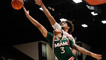 Jan 22, 2025; Stanford, California, USA; Miami (FL) Hurricanes guard Jalil Bethea (3) attempts a layup against Stanford Cardinal forward Donavin Young (2) in the first half at Maples Pavilion. Mandatory Credit: Eakin Howard-Imagn Images