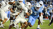 Nov 8, 2025; Chapel Hill, North Carolina, USA;  Stanford Cardinal running back Cole Tabb (33) with the ball as North Carolina Tar Heels linebacker Khmori House (7) defends in the third quarter at Kenan Stadium. Mandatory Credit: Bob Donnan-Imagn Images