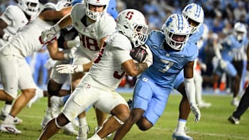 Nov 8, 2025; Chapel Hill, North Carolina, USA;  Stanford Cardinal running back Cole Tabb (33) with the ball as North Carolina Tar Heels linebacker Khmori House (7) defends in the third quarter at Kenan Stadium. Mandatory Credit: Bob Donnan-Imagn Images