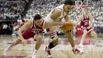 Wisconsin guard John Tonje gets to a loose ball ahead of Indiana guard Trey Galloway during the first half Tuesday night at the Kohl Center in Madison.