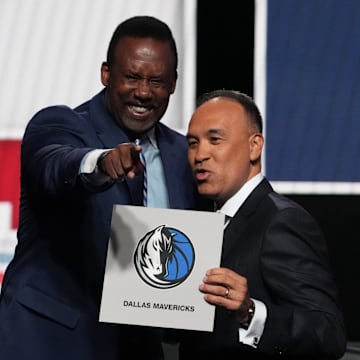 Rolando Blackman of the Dallas Mavericks reacts with Mark Tatum NBA Deputy Commissioner after winning the the first pick.