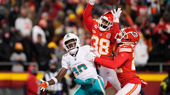 Jan 13, 2024; Kansas City, Missouri, USA; Kansas City Chiefs cornerback L'Jarius Sneed (38) and cornerback Trent McDuffie (22) break up a pass intended for Miami Dolphins wide receiver Tyreek Hill (10) during the second half of the 2024 AFC wild card game at GEHA Field at Arrowhead Stadium. Mandatory Credit: Jay Biggerstaff-Imagn Images