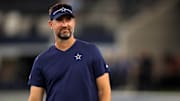 Dallas Cowboys offensive coordinator Brian Schottenheimer on the field before the game against the Las Vegas Raiders.