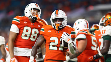 Sep 7, 2024; Miami Gardens, Florida, USA; Miami Hurricanes running back Jordan Lyle (21) reacts after running with the football against the Florida A&M Rattlers during the third quarter at Hard Rock Stadium. Mandatory Credit: Sam Navarro-Imagn Images