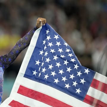 Aug 1, 2024; Paris, France; Simone Biles of the United States celebrates after winning gold in the women's gymnastics all-around during the Paris 2024 Olympic Summer Games at Bercy Arena.