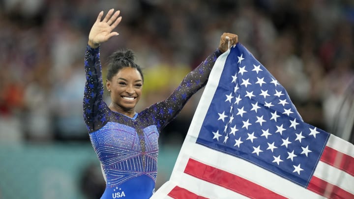 Aug 1, 2024; Paris, France; Simone Biles of the United States celebrates after winning gold in the women's gymnastics all-around during the Paris 2024 Olympic Summer Games at Bercy Arena.