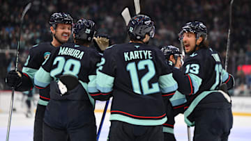 Nov 16, 2024; Seattle, Washington, USA; The Seattle Kraken celebrate after a goal scored by center Yanni Gourde (37) (not pictured) during the first period against the New York Islanders at Climate Pledge Arena. Mandatory Credit: Steven Bisig-Imagn Images