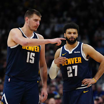 Apr 10, 2024; Denver, Colorado, USA; Denver Nuggets center Nikola Jokic (15) and guard Jamal Murray (27) talk in the fourth quarter against the Minnesota Timberwolves at Ball Arena. Mandatory Credit: Ron Chenoy-Imagn Images