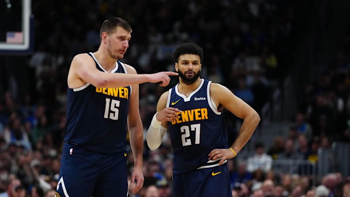 Apr 10, 2024; Denver, Colorado, USA; Denver Nuggets center Nikola Jokic (15) and guard Jamal Murray (27) talk in the fourth quarter against the Minnesota Timberwolves at Ball Arena. Mandatory Credit: Ron Chenoy-Imagn Images