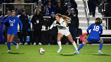 Dec 6, 2024; Cary, NC, USA; North Carolina fm Kate Faasse (13) with the ball as Duke midfielder Hannah Bebar (18) and midfielder Carina Lageyre (16) defend in the first half at WakeMed Soccer Park. Mandatory Credit: Bob Donnan-Imagn Images