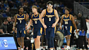Nov 16, 2024; Omaha, Nebraska, USA;  UMKC Kangaroos guard Jamar Brown (5) leads guard Kasheem Grady II (7) and guard Anderson Kopp (11) and center Melvyn Ebonkoli (20) on the court after a timeout against the Creighton Bluejays in the second half at CHI Health Center Omaha. Mandatory Credit: Steven Branscombe-Imagn Images