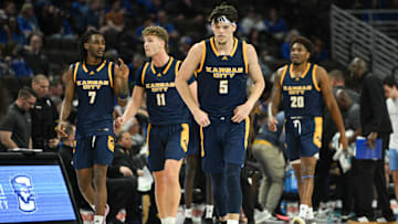 Nov 16, 2024; Omaha, Nebraska, USA;  UMKC Kangaroos guard Jamar Brown (5) leads guard Kasheem Grady II (7) and guard Anderson Kopp (11) and center Melvyn Ebonkoli (20) on the court after a timeout against the Creighton Bluejays in the second half at CHI Health Center Omaha. Mandatory Credit: Steven Branscombe-Imagn Images