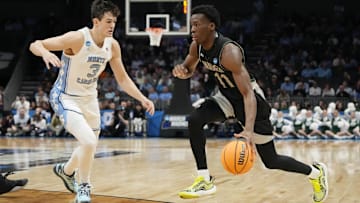 March 21, 2024, Charlotte, NC, USA; Wagner Seahawks guard Melvin Council Jr. (11) is defended by North Carolina Tar Heels guard Cormac Ryan (3) in the first round of the 2024 NCAA Tournament at the Spectrum Center. Mandatory Credit: Jim Dedmon-Imagn Images