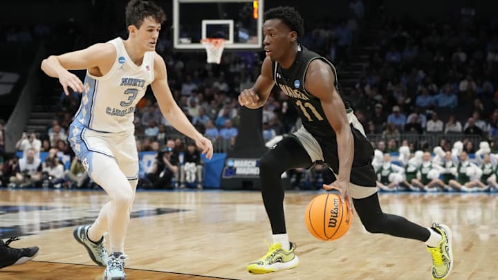 March 21, 2024, Charlotte, NC, USA; Wagner Seahawks guard Melvin Council Jr. (11) is defended by North Carolina Tar Heels guard Cormac Ryan (3) in the first round of the 2024 NCAA Tournament at the Spectrum Center. Mandatory Credit: Jim Dedmon-Imagn Images
