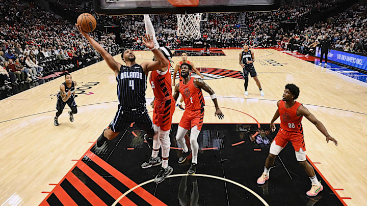 Oct 27, 2023; Portland, Oregon, USA; Orlando Magic guard Jalen Suggs (4) drives to the basket during the first half against Portland Trail Blazers center Robert Williams III (35) at Moda Center. Mandatory Credit: Troy Wayrynen-Imagn Images