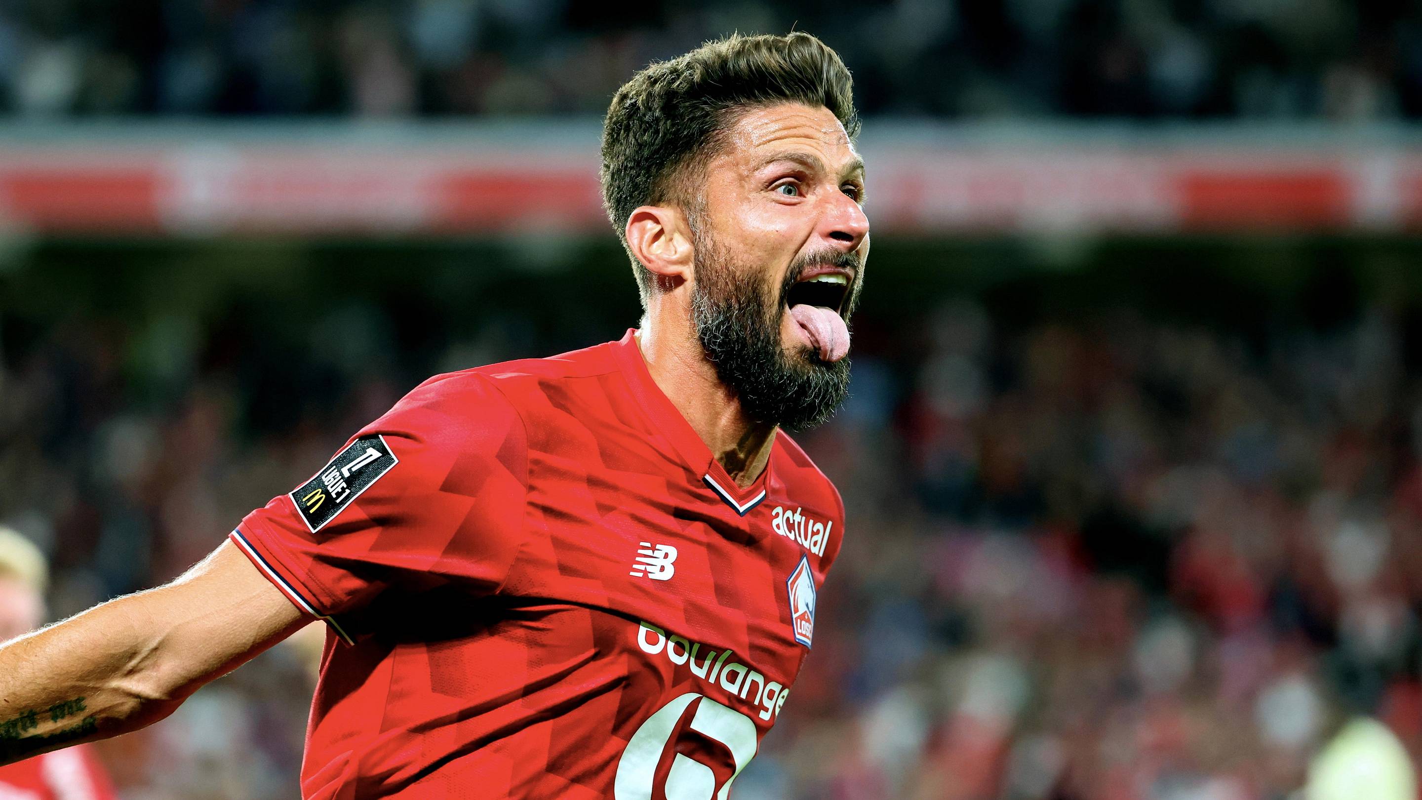 Olivier Giroud celebrating in the current Lille home kit