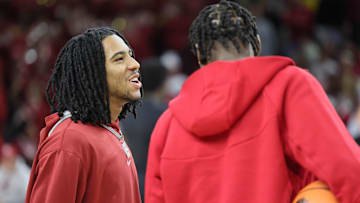 Mar 8, 2025; Fayetteville, Arkansas, USA; Arkansas Razorbacks guard Boogie Fland talks to forward Adou Thiero prior to the game against the Mississippi State Bulldogs at Bud Walton Arena. Mandatory Credit: Nelson Chenault-Imagn Images
