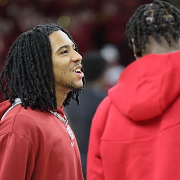 Arkansas Razorbacks guard Boogie Fland talks to forward Adou Thiero prior to the game against the Mississippi State Bulldogs at Bud Walton Arena. 