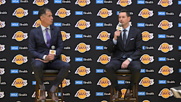 Jun 24, 2024; El Segundo, CA, USA; Los Angeles Lakers general manager Rob Pelinka loosk on as head coach JJ Redick speaks to the media during an introductory news conference at the UCLA Health Training Center. Mandatory Credit: Jayne Kamin-Oncea-Imagn Images