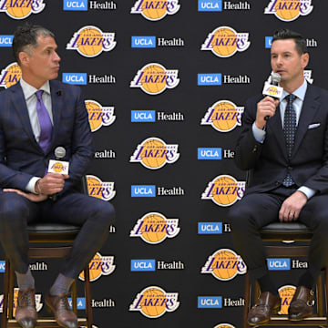 Jun 24, 2024; El Segundo, CA, USA; Los Angeles Lakers general manager Rob Pelinka loosk on as head coach JJ Redick speaks to the media during an introductory news conference at the UCLA Health Training Center. Mandatory Credit: Jayne Kamin-Oncea-Imagn Images