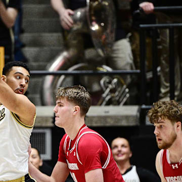 Feb 15, 2025; West Lafayette, Indiana, USA; Purdue Boilermakers forward Trey Kaufman-Renn (4) keeps the ball away from Wisconsin Badgers forward Nolan Winter (31) during the first half at Mackey Arena. Mandatory Credit: Marc Lebryk-Imagn Images