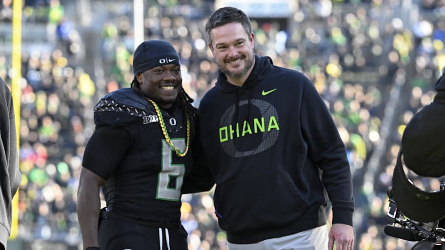 Oregon running back Noah Whittington poses for a photo with head coach Dan Lanning before the game against USC.