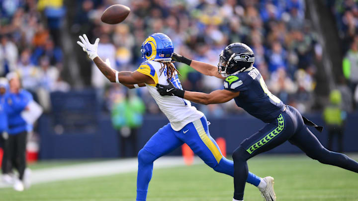 Nov 3, 2024; Seattle, Washington, USA; Los Angeles Rams wide receiver Demarcus Robinson (15) catches a pass while defended by Seattle Seahawks cornerback Coby Bryant (8) during the first half at Lumen Field. Mandatory Credit: Steven Bisig-Imagn Images