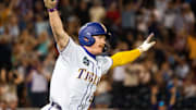 Jun 18, 2025; Omaha, Neb, USA; LSU Tigers first baseman Jared Jones (22) celebrates after hitting a walk off RBI single against the Arkansas Razorbacks during the ninth inning at Charles Schwab Field. Mandatory Credit: Dylan Widger-Imagn Images