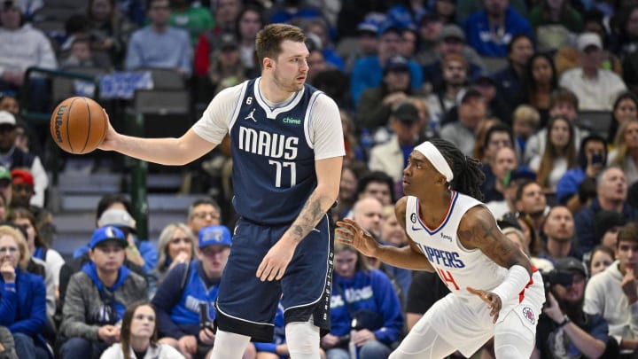 Jan 22, 2023; Dallas, Texas, USA; Dallas Mavericks guard Luka Doncic (77) and LA Clippers guard Terance Mann (14) in action during the game between the Dallas Mavericks and the LA Clippers at the American Airlines Center. Mandatory Credit: Jerome Miron-USA TODAY Sports