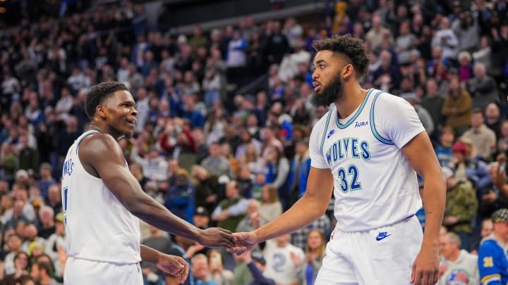 Jan 18, 2024; Minneapolis, Minnesota, USA; Minnesota Timberwolves guard Anthony Edwards (5) and center Karl-Anthony Towns (32) celebrate against the Memphis Grizzlies in the fourth quarter at Target Center. Mandatory Credit: Brad Rempel-USA TODAY Sports