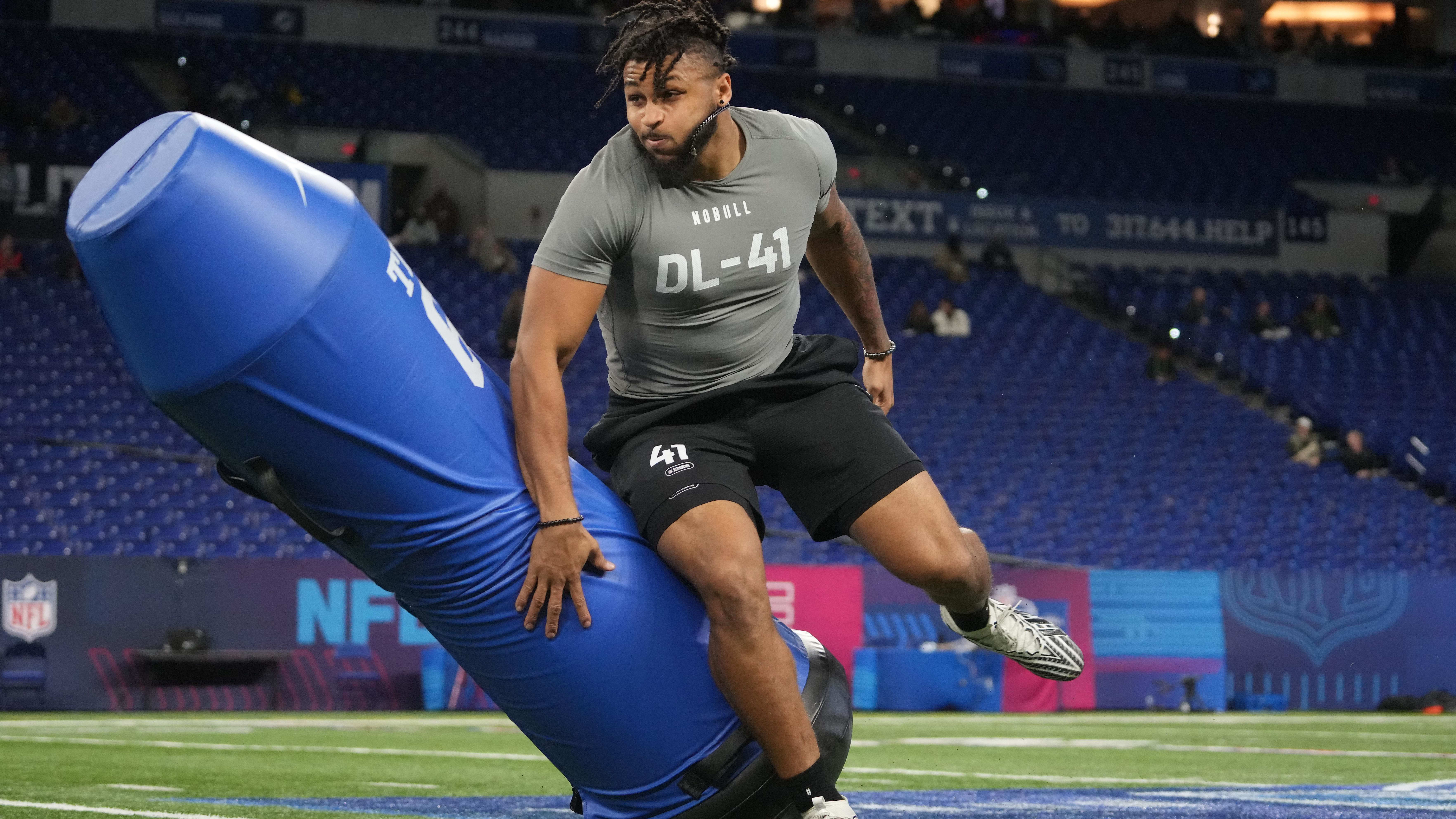 Western Michigan defensive lineman Marshawn Kneeland (DL41) runs through field drills at the NFL Scouting Combine