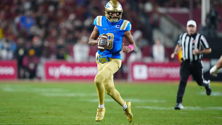 Nov 29, 2025; Los Angeles, California, USA; UCLA Bruins quarterback Nico Iamaleava (9) carries the ball against the Southern California Trojans in the first half at United Airlines Field at Los Angeles Memorial Coliseum. Mandatory Credit: Kirby Lee-Imagn Images
