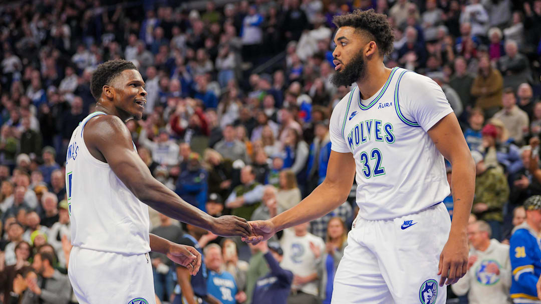 Jan 18, 2024; Minneapolis, Minnesota, USA; Minnesota Timberwolves guard Anthony Edwards (5) and center Karl-Anthony Towns (32) celebrate against the Memphis Grizzlies in the fourth quarter at Target Center.