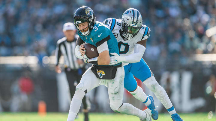 Dec 31, 2023; Jacksonville, Florida, USA; Carolina Panthers linebacker Brian Burns (0) tackles Jacksonville Jaguars quarterback C.J. Beathard (3) in the third quarter at EverBank Stadium. Mandatory Credit: Jeremy Reper-USA TODAY Sports