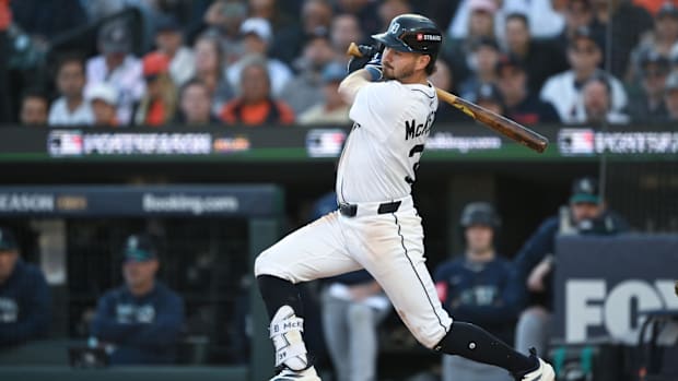 McKinstry hitting a single in a white uniform against the Mariner