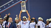 Texas Rangers second baseman Marcus Semien (2) raises the trophy during the celebration outside of the ballpark after the World Series championship parade at Globe Life Field.