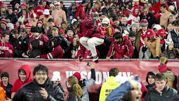 Nov 8, 2025; Madison, Wisconsin, USA;  Wisconsin Badgers students charge the field following the game against the Washington Huskies at Camp Randall Stadium. Mandatory Credit: Jeff Hanisch-Imagn Images