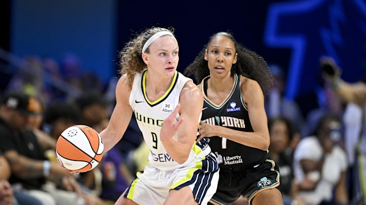 Dallas Wings guard Grace Berger looks to move the ball past New York Liberty guard Rebekah Gardner Dallas Wings guard Grace Berger looks to move the ball past New York Liberty guard Rebekah Gardner