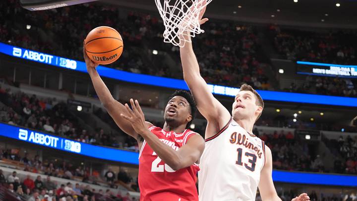 Mar 13, 2026; Chicago, IL, USA; Illinois Fighting Illini center Tomislav Ivisic (13) defends Wisconsin Badgers guard John Blackwell (25) during the second half at United Center. Mandatory Credit: David Banks-Imagn Images