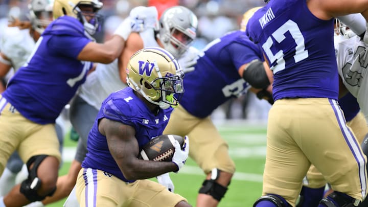 Sep 7, 2024; Seattle, Washington, USA; Washington Huskies running back Jonah Coleman (1) carries the ball against the Eastern Michigan Eagles during the first half at Alaska Airlines Field at Husky Stadium. Mandatory Credit: Steven Bisig-Imagn Images